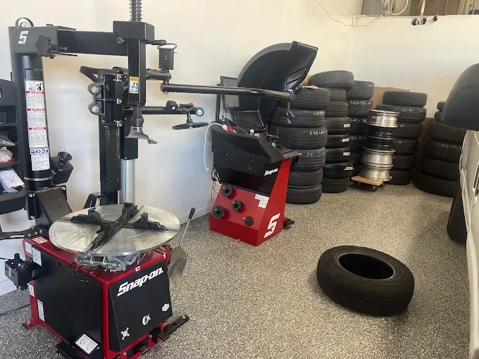 Tire changing machine and wheel balancer inside the Los Alamitos shop