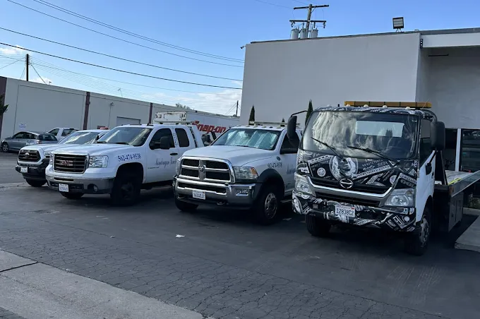 Mondragon Towing fleet of tow trucks and service vehicles parked at the shop