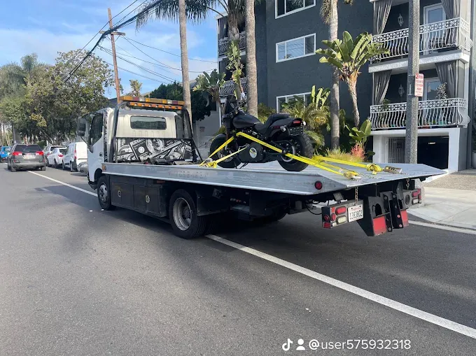 Motorcycle safely recovered and secured on a flatbed tow truck
